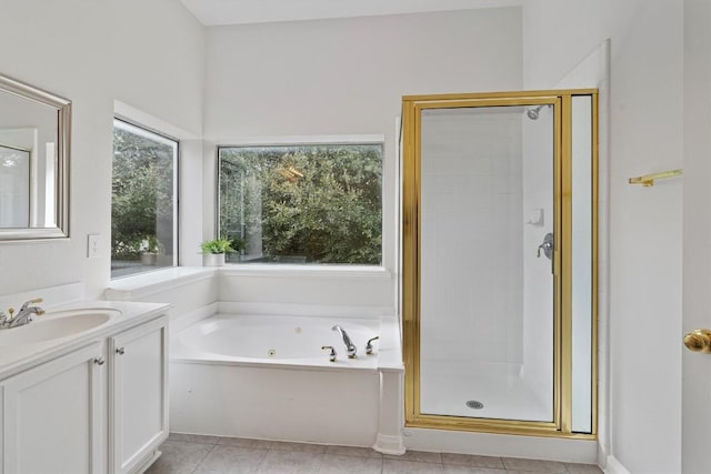 bathroom with plus walk in shower, vanity, and tile patterned floors