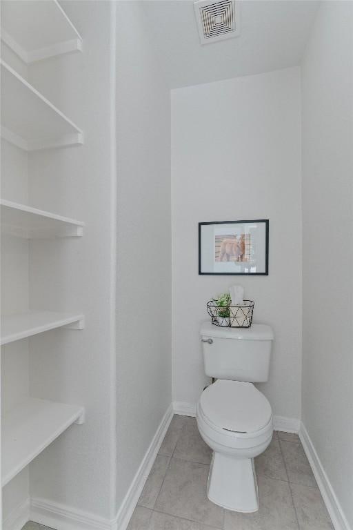 bathroom featuring tile patterned flooring and toilet