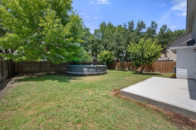 view of yard with a fenced in pool and a patio