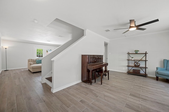 misc room featuring crown molding, ceiling fan, and light hardwood / wood-style floors