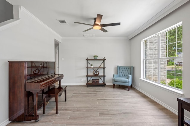 sitting room featuring crown molding, a healthy amount of sunlight, ceiling fan, and light hardwood / wood-style floors