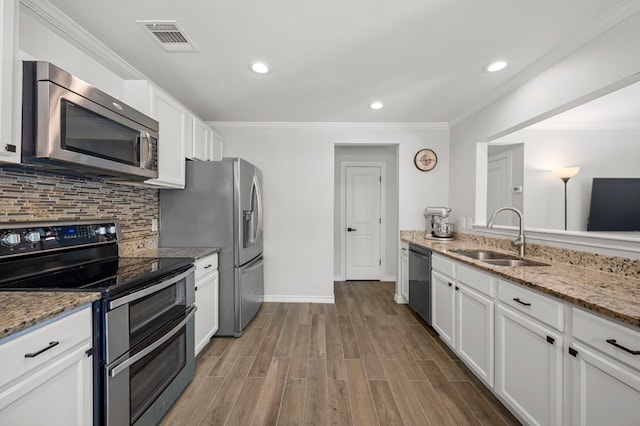 kitchen with sink, white cabinets, and appliances with stainless steel finishes