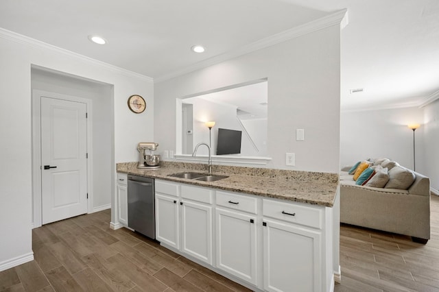 kitchen with light stone counters, dishwasher, sink, and white cabinets