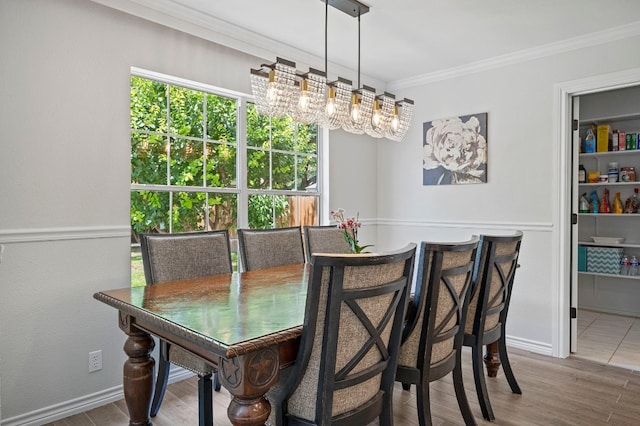 dining area with ornamental molding, plenty of natural light, and wood-type flooring