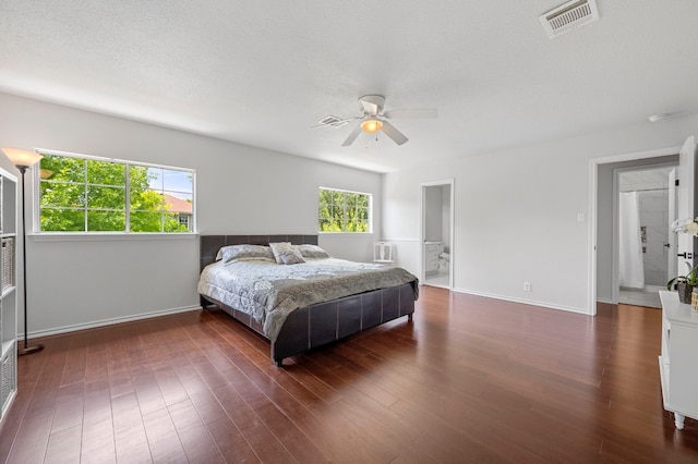 bedroom featuring ceiling fan, dark hardwood / wood-style flooring, and a textured ceiling