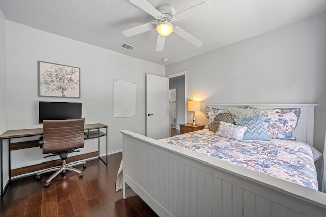 bedroom featuring ceiling fan, dark hardwood / wood-style floors, and a textured ceiling