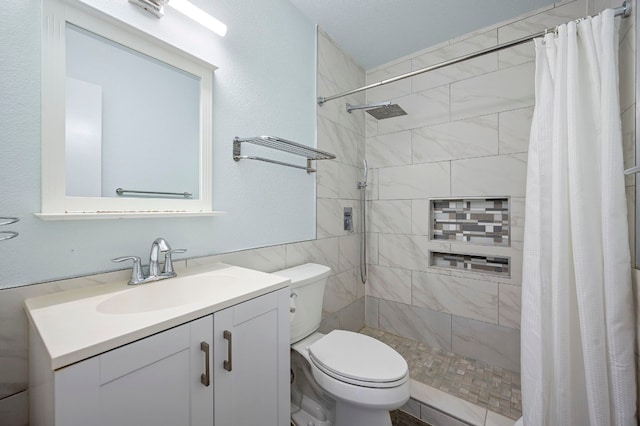 bathroom featuring vanity, curtained shower, and toilet