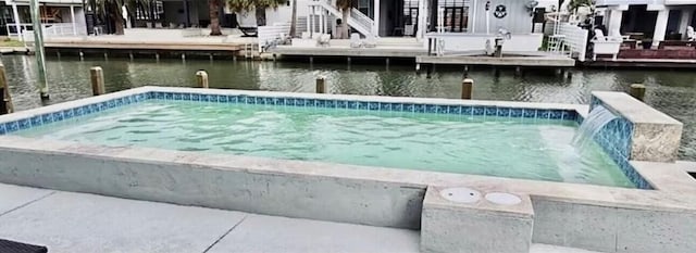 view of swimming pool featuring a water view