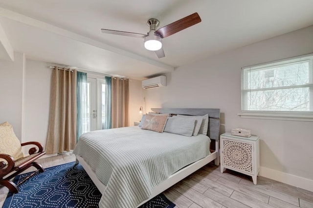 bedroom featuring ceiling fan, an AC wall unit, and multiple windows