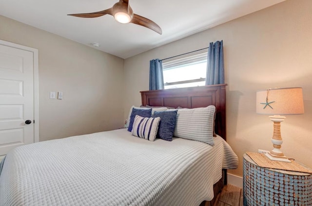 bedroom featuring ceiling fan and hardwood / wood-style flooring