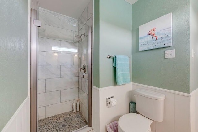 bathroom with toilet and an enclosed shower