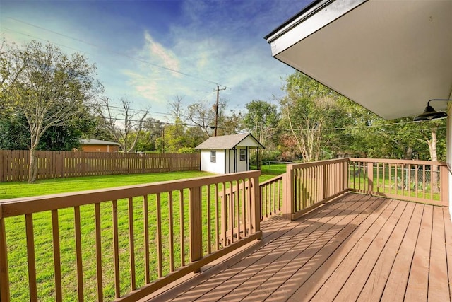 wooden deck with a shed and a yard