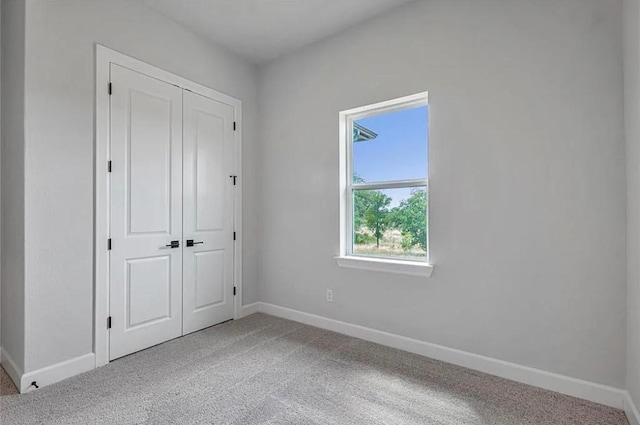 unfurnished bedroom with carpet flooring and a closet