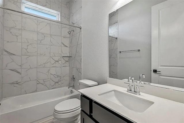 full bathroom featuring toilet, vanity, and tiled shower / bath