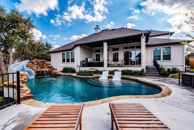 outdoor pool with a patio and fence