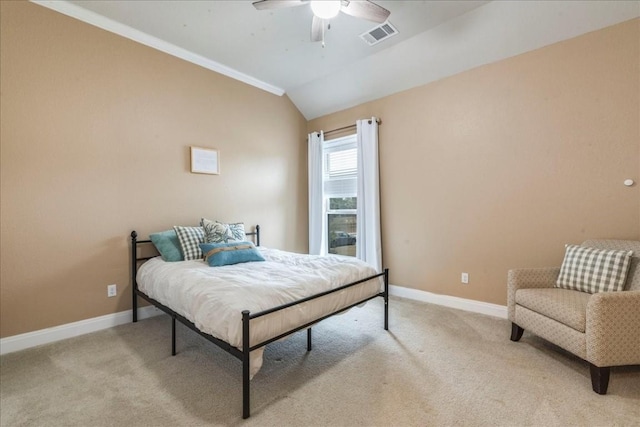 bedroom with lofted ceiling, light colored carpet, visible vents, and baseboards