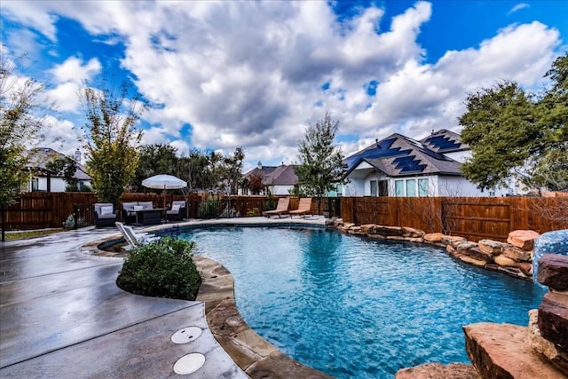 view of pool featuring a patio area, a fenced backyard, an outdoor living space, and a fenced in pool