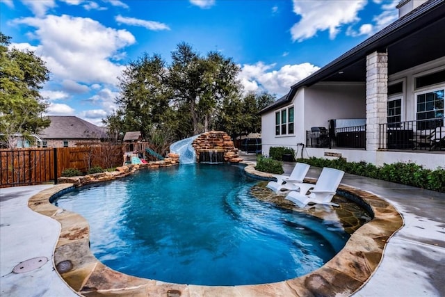 view of pool featuring a fenced in pool, fence, a water slide, a patio area, and a playground