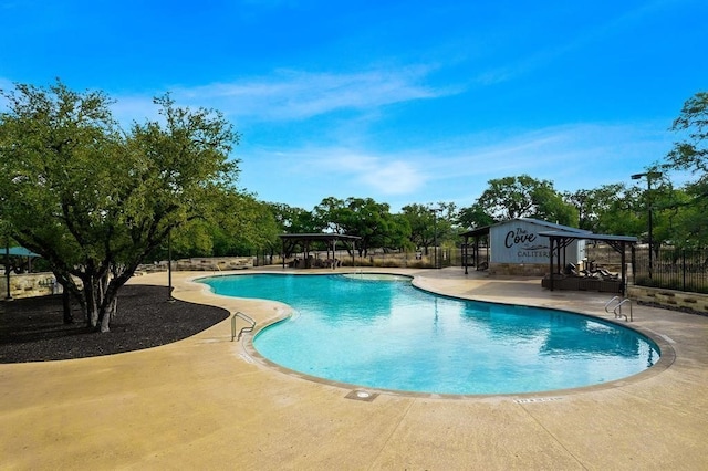 pool featuring a patio area, fence, and a gazebo