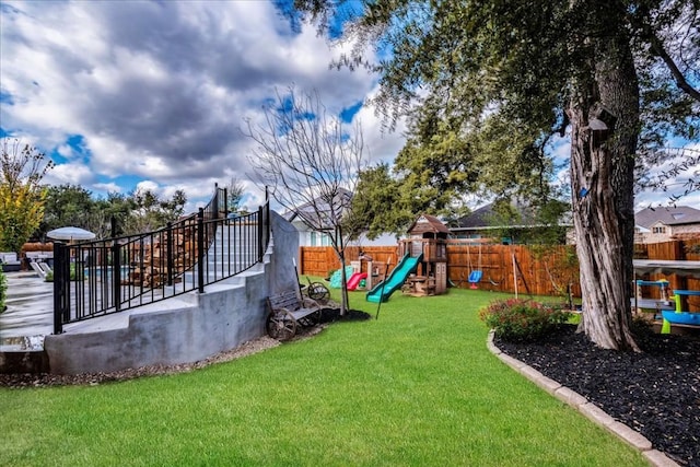 view of yard with a fenced backyard and a playground