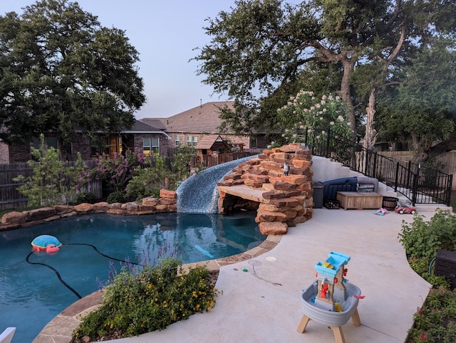 view of swimming pool featuring a patio area, a fenced backyard, and a fenced in pool