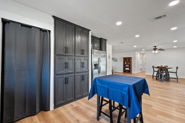 dining space featuring ceiling fan and light hardwood / wood-style floors