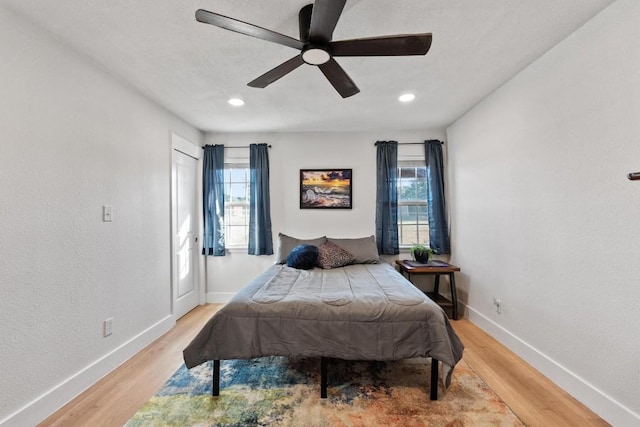 bedroom with ceiling fan and light wood-type flooring