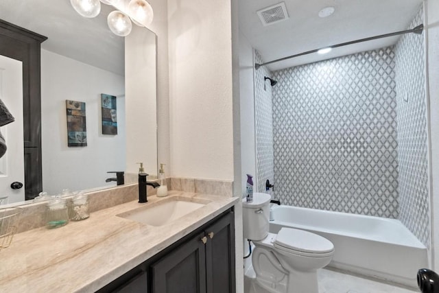 full bathroom featuring toilet, vanity, and tiled shower / bath