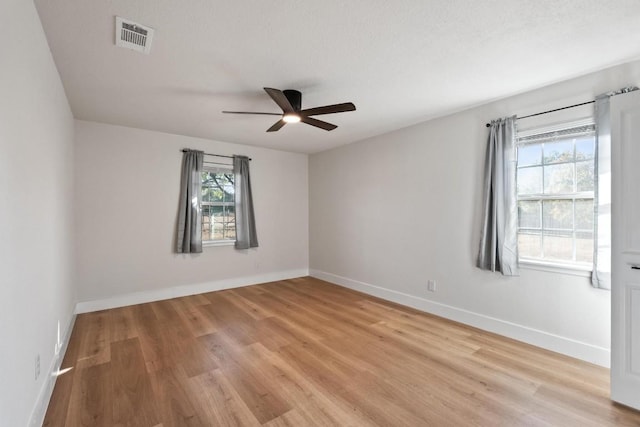 unfurnished room featuring ceiling fan, plenty of natural light, and light hardwood / wood-style floors