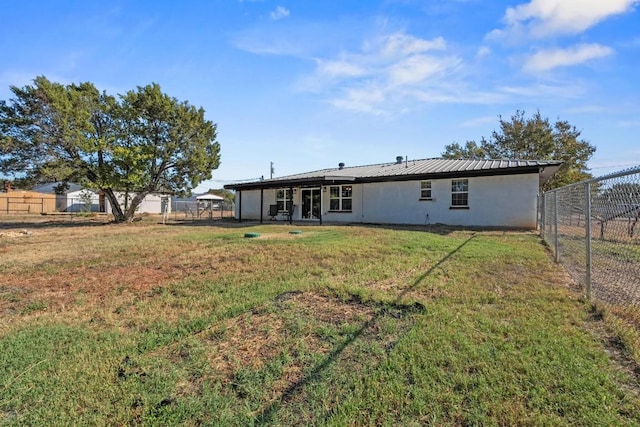 back of house with a yard