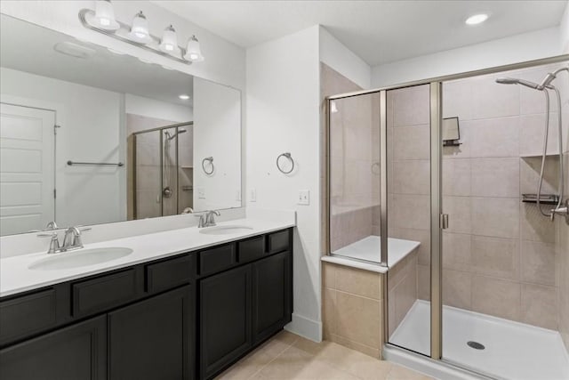 bathroom with tile patterned flooring, vanity, and an enclosed shower