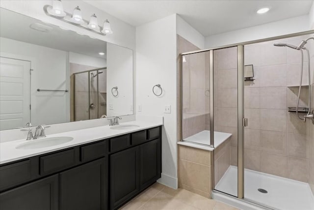 7411 Merrick Ln Unit 39, Austin, TX 78745 - full bath featuring tile patterned flooring, a shower stall, double vanity, and recessed lighting