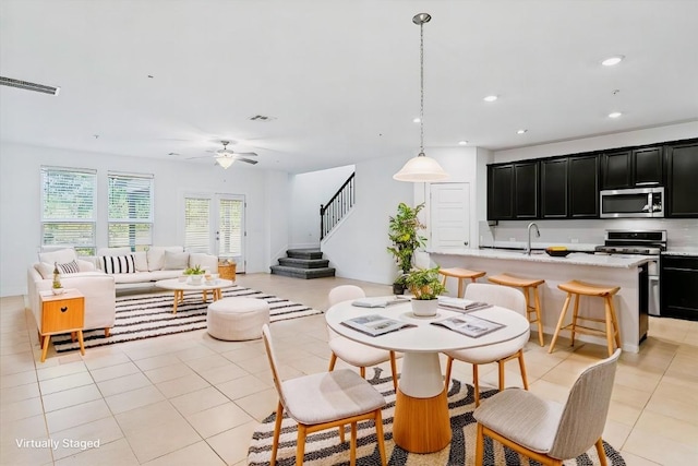 7411 Merrick Ln Unit 39, Austin, TX 78745 - dining room featuring ceiling fan, stairway, light tile patterned flooring, and recessed lighting