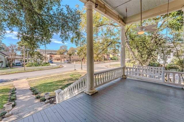 wooden terrace featuring ceiling fan and a porch