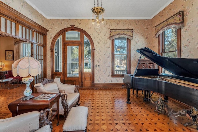 living area with ornamental molding, light parquet flooring, and a notable chandelier