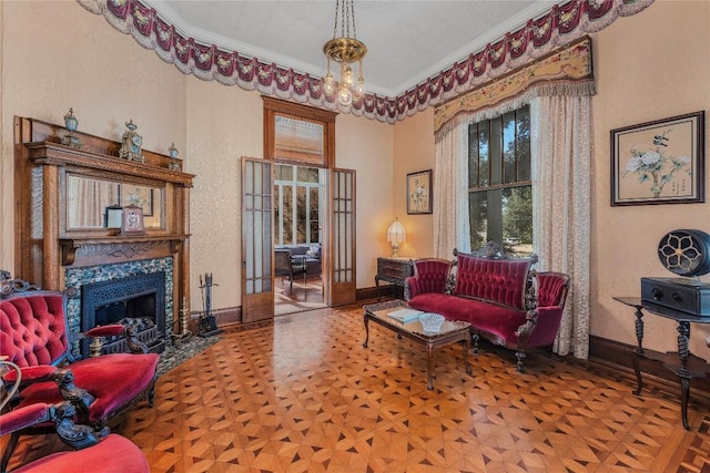 sitting room with french doors, parquet floors, ornamental molding, a notable chandelier, and a premium fireplace