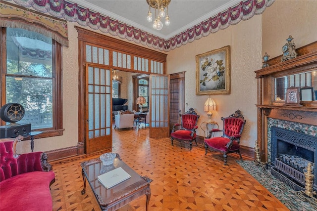 living room with parquet floors, crown molding, a high end fireplace, and french doors