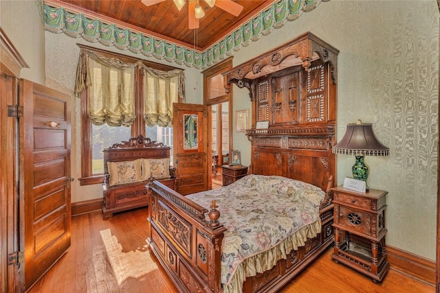 524 Saint Peter St, Gonzales, TX 78629 - bedroom featuring wooden ceiling, wood-type flooring, and wallpapered walls