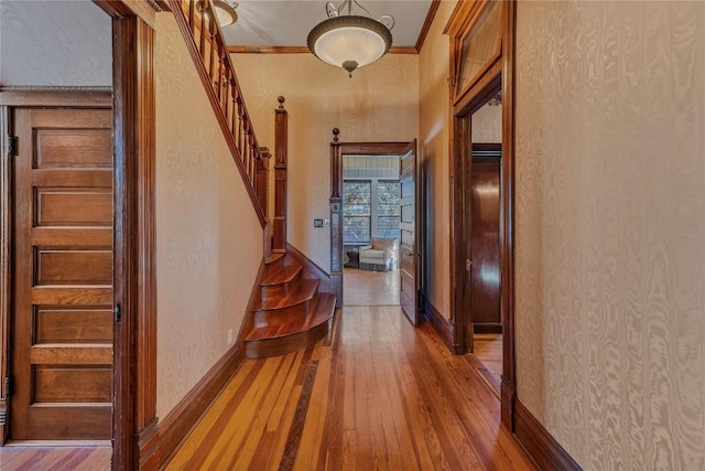 524 Saint Peter St, Gonzales, TX 78629 - hallway featuring wood finished floors, ornamental molding, and stairs
