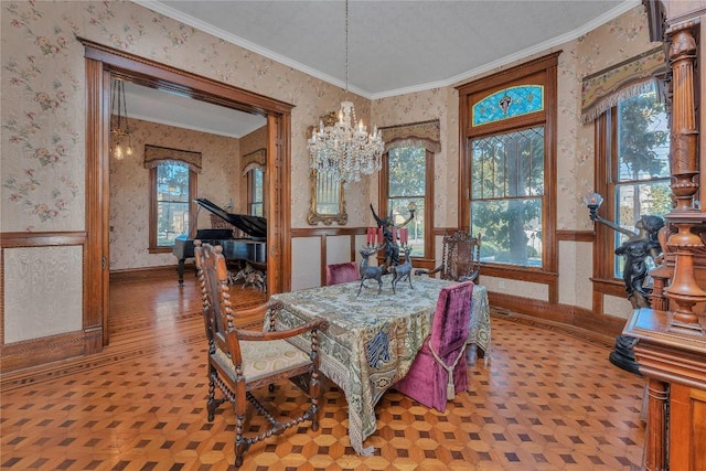 524 Saint Peter St, Gonzales, TX 78629 - dining room featuring wallpapered walls, a chandelier, a wainscoted wall, crown molding, and wood finished floors