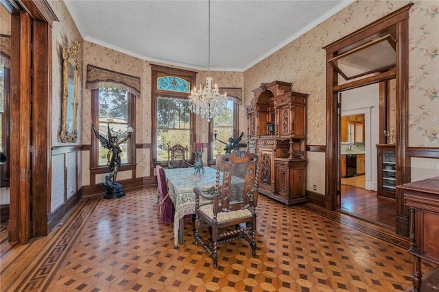 dining area featuring crown molding, a textured ceiling, and an inviting chandelier