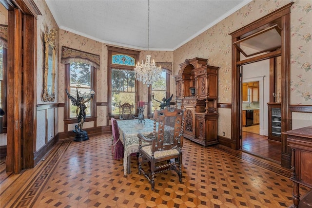 524 Saint Peter St, Gonzales, TX 78629 - dining space featuring wallpapered walls, a wainscoted wall, a chandelier, ornamental molding, and a textured ceiling