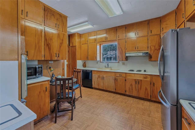 kitchen featuring sink, backsplash, light parquet floors, and appliances with stainless steel finishes