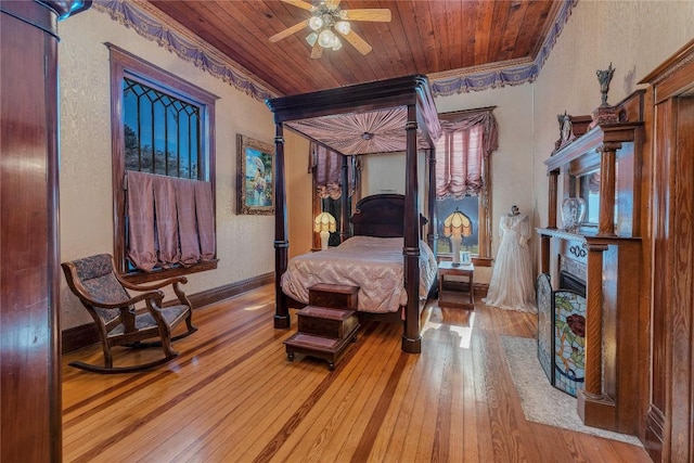 524 Saint Peter St, Gonzales, TX 78629 - bedroom with wood-type flooring, crown molding, a fireplace with flush hearth, and wooden ceiling