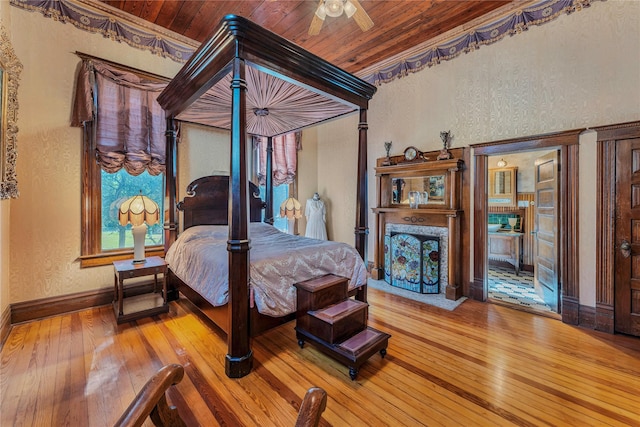 bedroom with wood ceiling, ceiling fan, and hardwood / wood-style floors