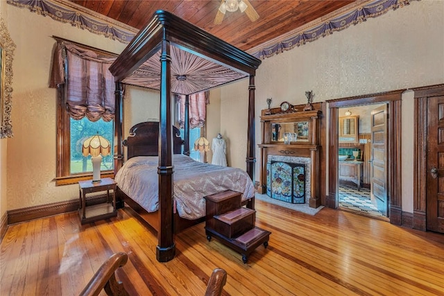 524 Saint Peter St, Gonzales, TX 78629 - bedroom featuring hardwood / wood-style floors, wooden ceiling, and a textured wall