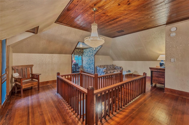 interior space with hardwood / wood-style floors, vaulted ceiling, and wooden ceiling