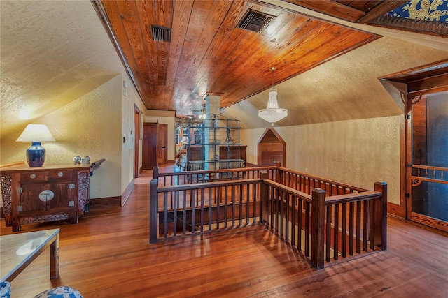 corridor with wood ceiling, vaulted ceiling, and hardwood / wood-style flooring