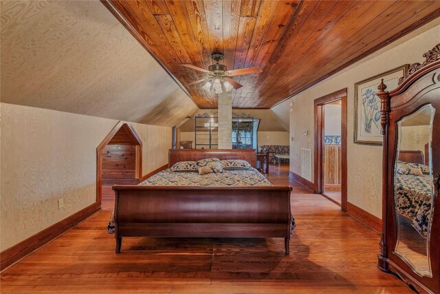 524 Saint Peter St, Gonzales, TX 78629 - bedroom featuring wood ceiling, hardwood / wood-style floors, lofted ceiling, and a textured wall