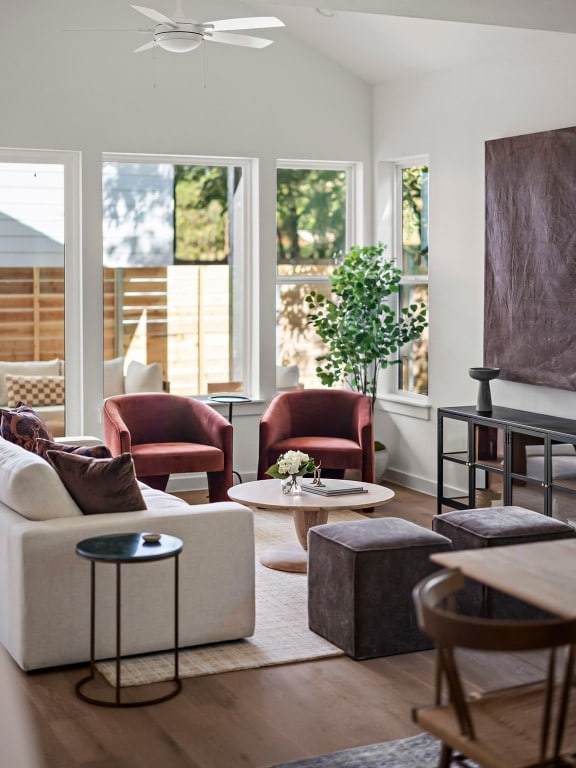 living room featuring hardwood / wood-style floors, vaulted ceiling, and ceiling fan